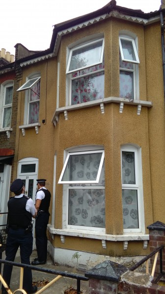 Police knock on the door of one of the East Ham properties